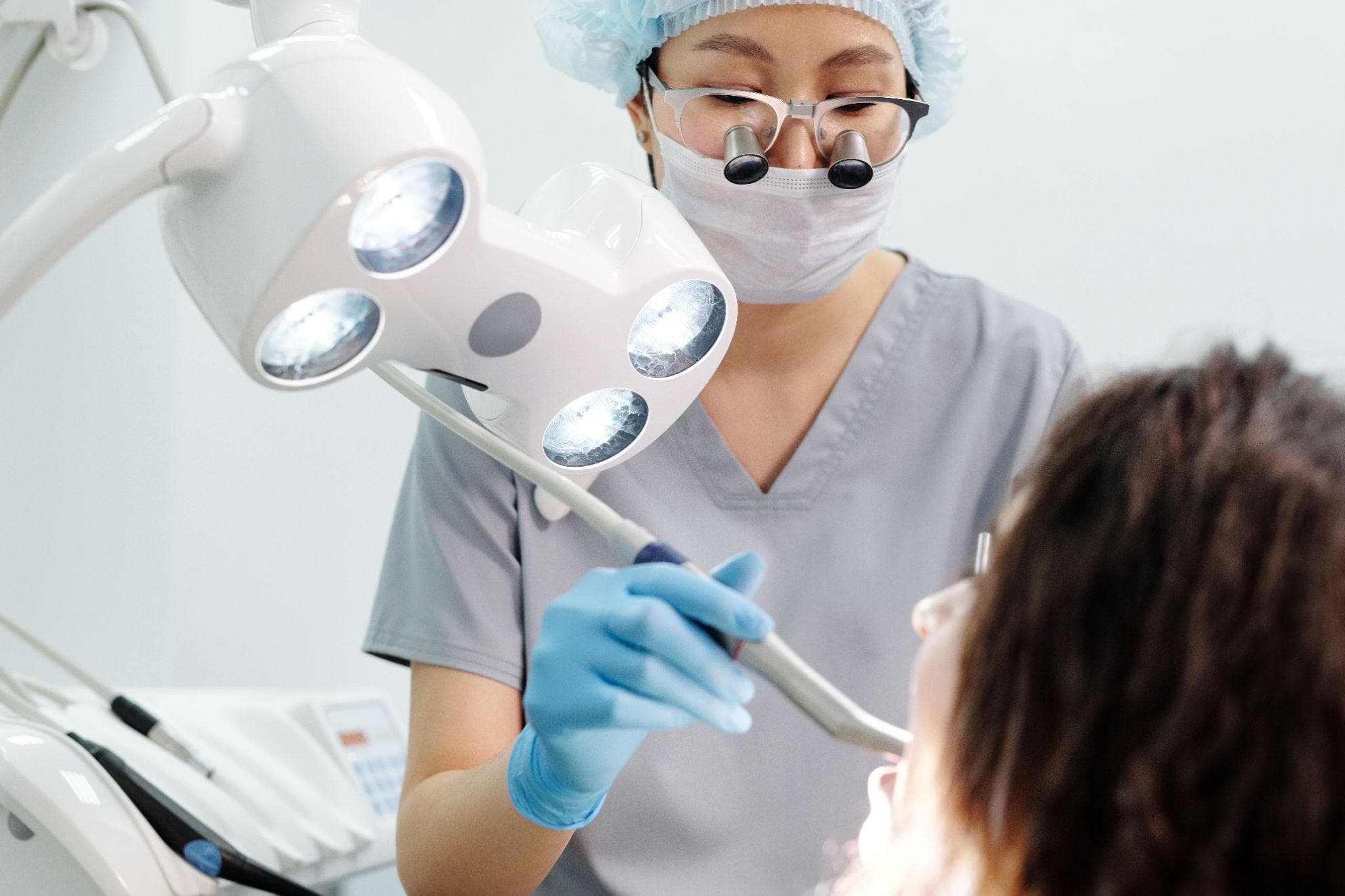 Dentist examining patient's teeth to assess dental filling options