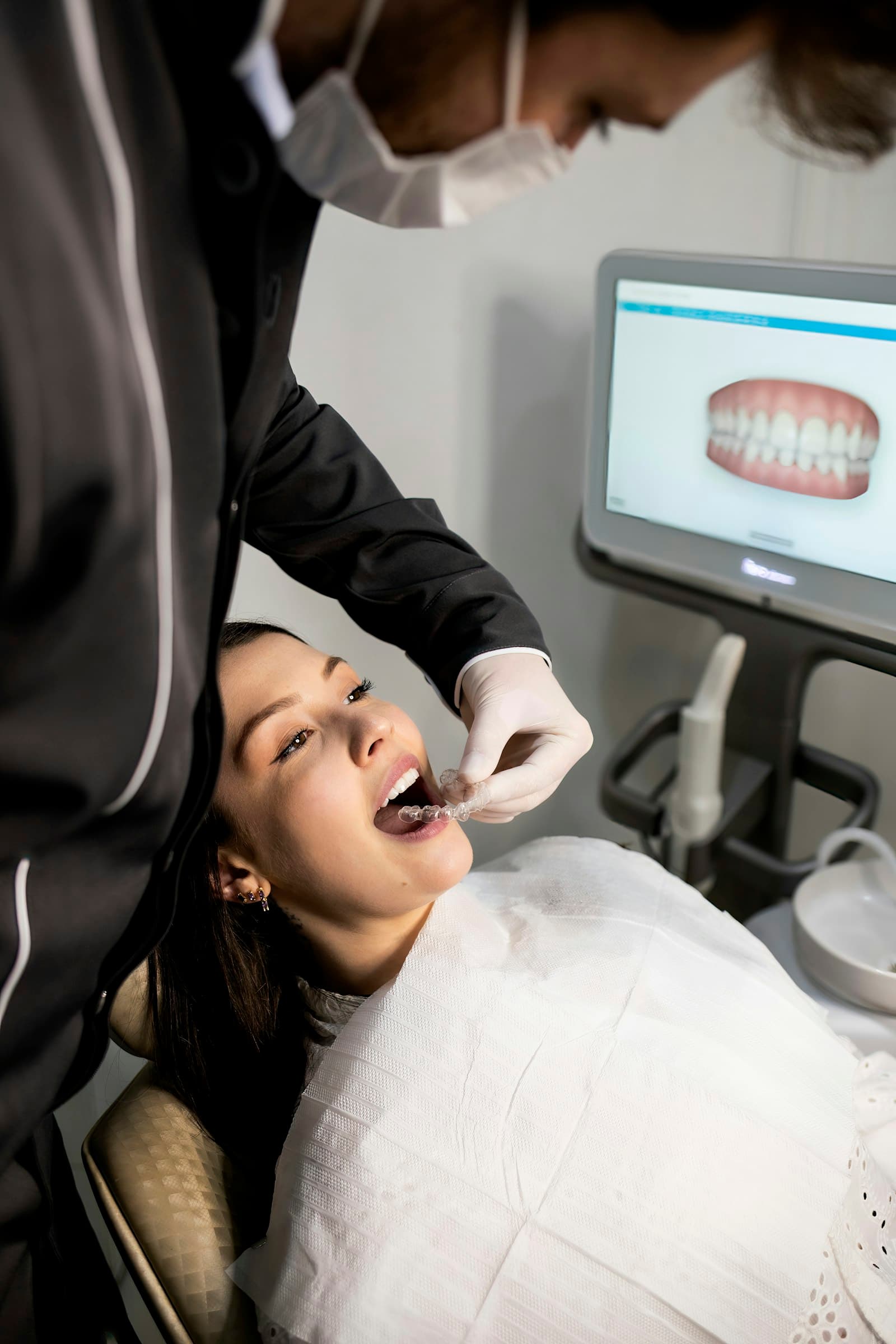 Dentist examining a patient's teeth in the dental chair