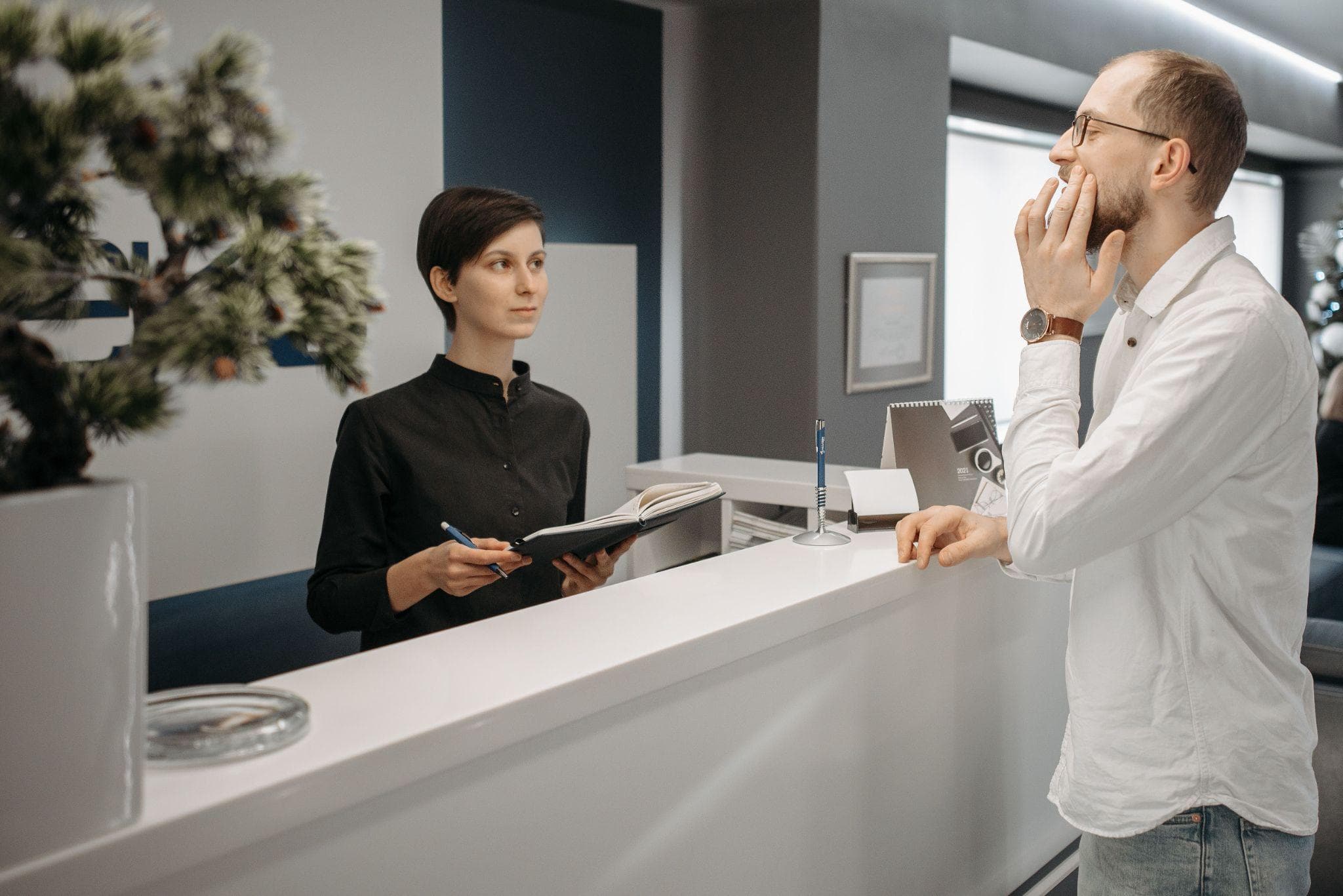 Patient asking about tooth filling costs at a dental clinic reception