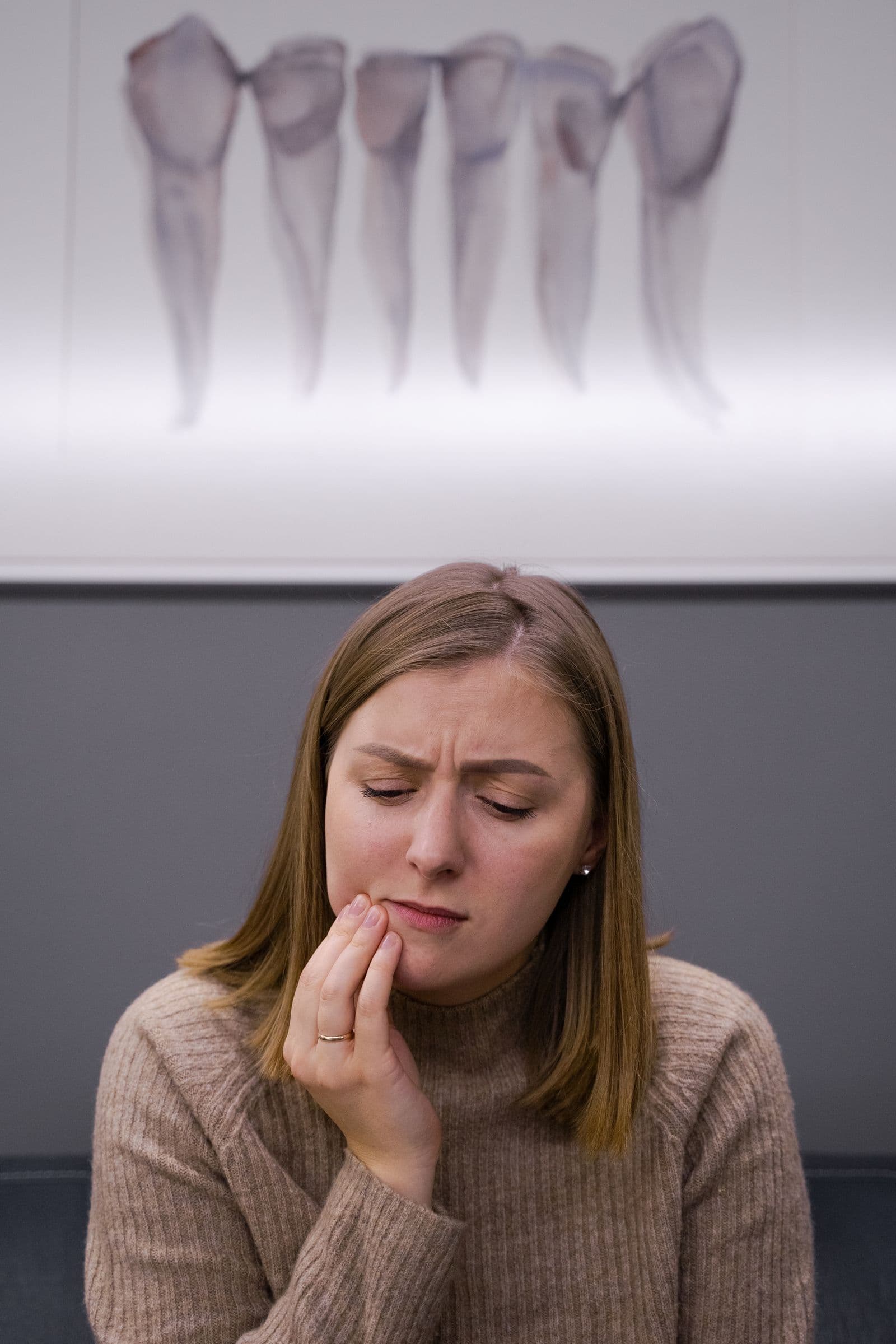 Woman holding her jaw in pain from a toothache